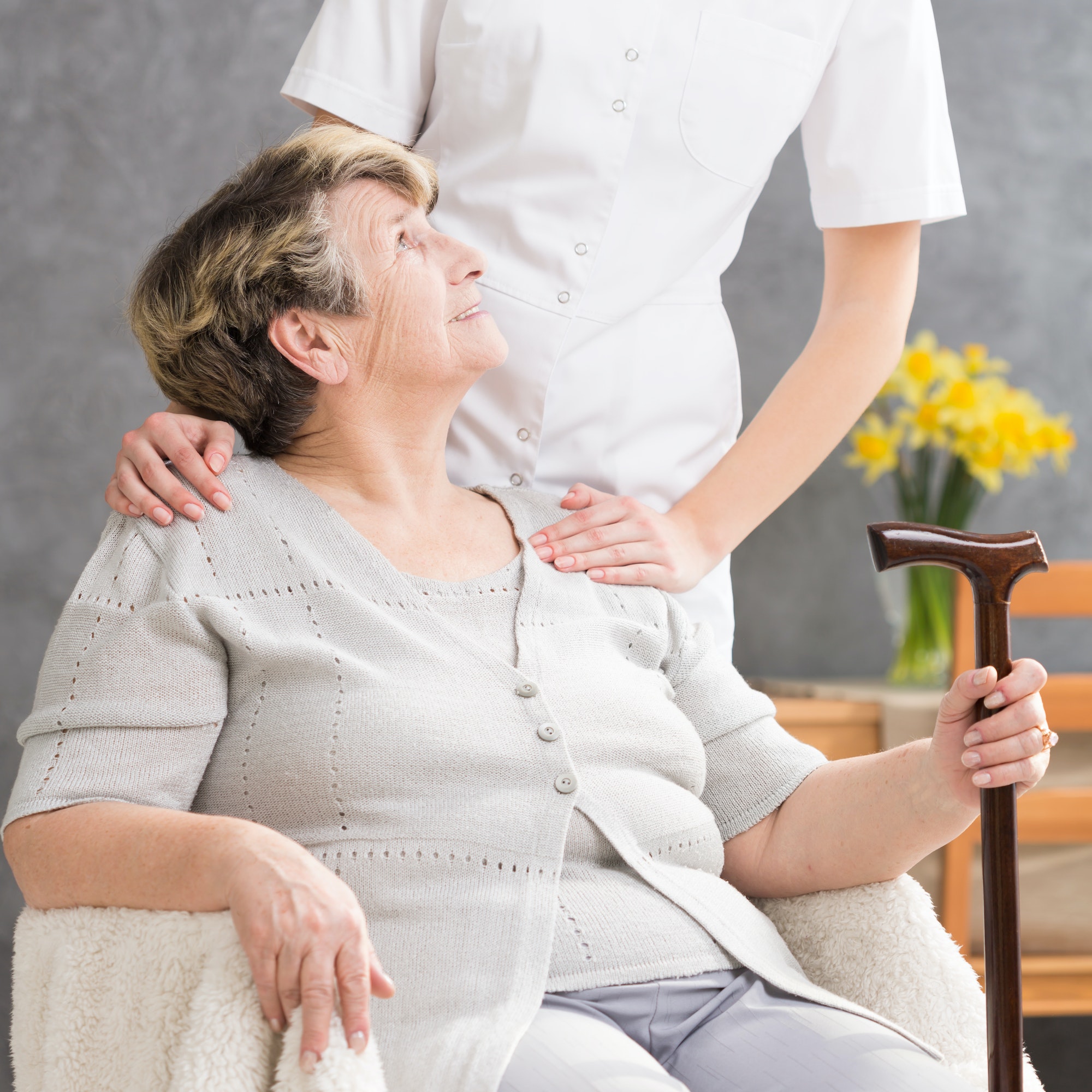 Senior lady needing help from caregiver